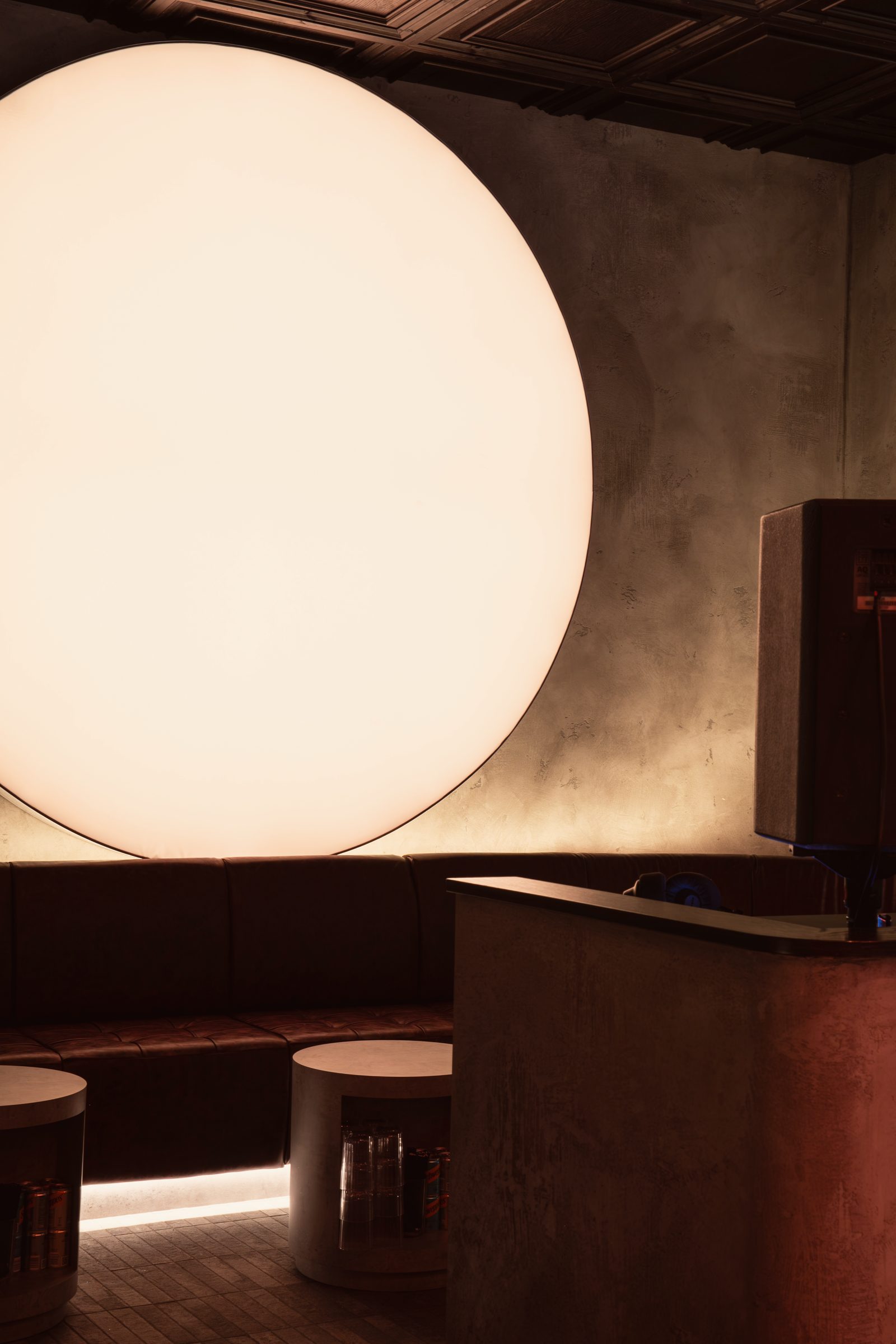 The Club Room: the sun glowing above a leather banquette and the DJ booth