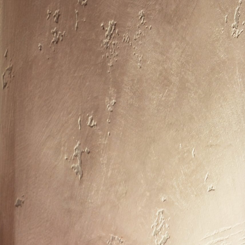 Plaster wall lit from a sconce