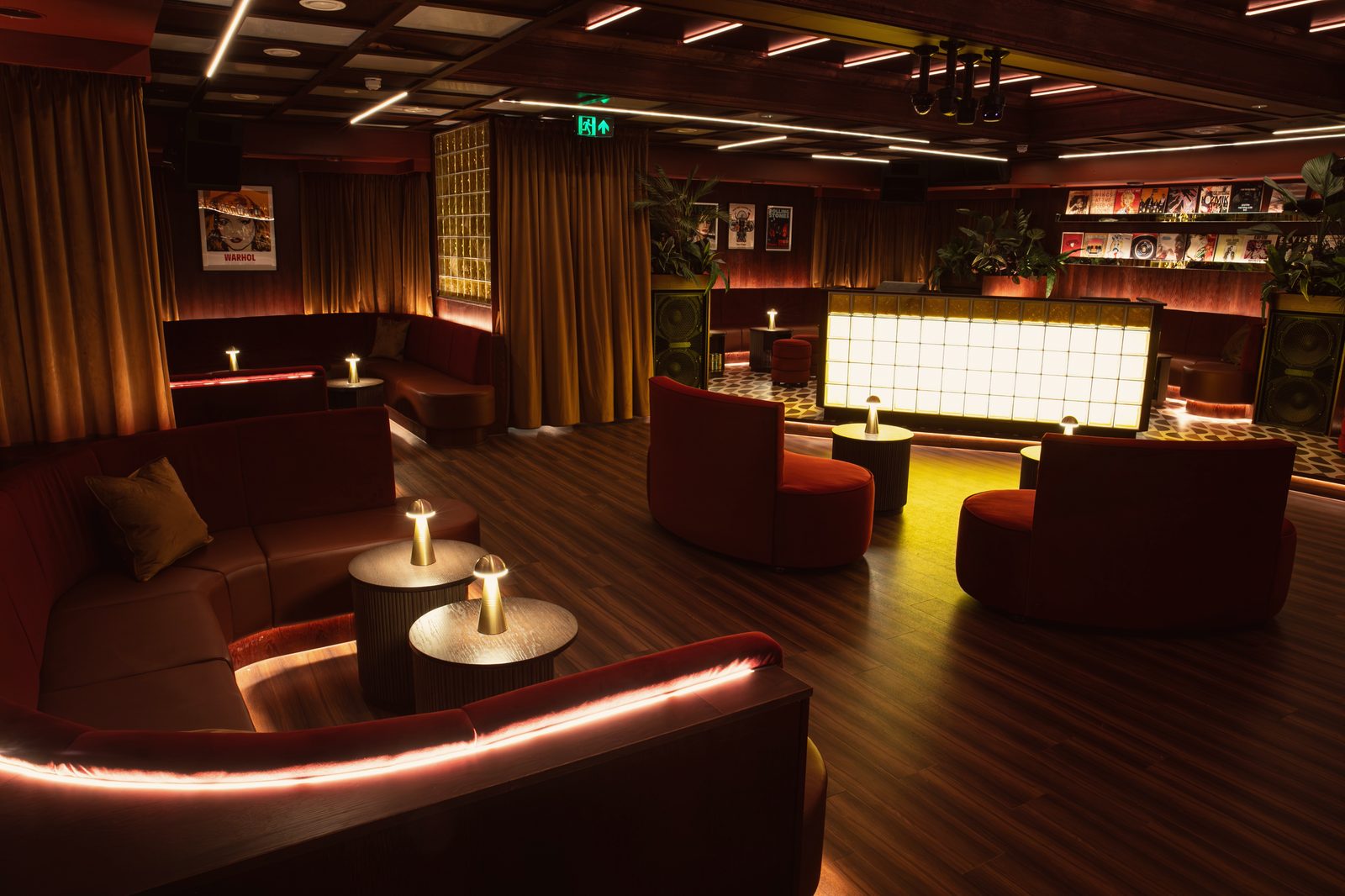 The Vinyl Room: velvet banquettes and curtains, the glowing glass-block DJ booth and a wall of record sleeves
